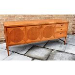 A 1970S NATHAN 'CIRCLES' TEAK SIDEBOARD with central two door cupboard flanked by drop-down cupboard