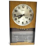A SEIKO 'TIME DATER' QUARTZ MOVEMENT WALL CLOCK with 30 day movement, day and date aperture, in wood