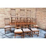 AN ERCOL 'GOLDEN DAWN' EXTENDING DINING TABLE and set of eight chairs including a carver from the '