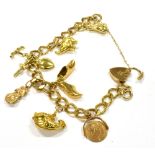 A 9CT GOLD CHARM BRACELET with seven charms and a padlock fastener, five of the charms hallmarked or