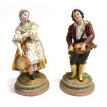 A PAIR OF VICTORIAN COLOURED BISQUE FIGURES OF MUSICIANS the gentleman playing a hurdy-gurdy, his