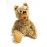 A HERMANN ZOTTY BLONDE MOHAIR TEDDY BEAR with orange glass eyes, a black vertically stitched nose,