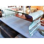 A CONTEMPORAY DESIGN TEMPERED GLASS COFFEE TABLE of wave form, 120cm long 60cm deep 43cm high