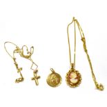 THREE 9CT GOLD PENDANTS Two with 9ct gold chains, comprising a cross with a very small