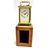 A BRASS CASED CARRIAGE CLOCK the enamel dial with Roman numerals, the movement stamped 'FRANCE',