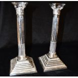 A PAIR OF SILVER CORINTHIAN COLUMN CANDLESTICKS the traditional form candlesticks with square