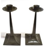 A PAIR OF JAMES DIXON PEWTER CANDLESTICKS IN THE MANNER OF LIBERTY with hammed and strapwork