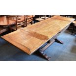 AN OAK DRAW-LEAF REFECTORY DINING TABLE on bulbous supports united by stretcher, 84cm deep 152cm