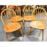 A SET OF FOUR LIGHT ERCOL BEECH AND ELM STICKBACK WINDSOR CHAIRS