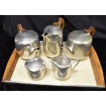 A COLLECTION OF PIQUOT WARE comprising two teapots, coffee pot, milk jug and sugar bowl, on matching