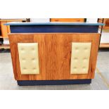A FORMICA TOP BAR the front with vinyl button upholstered pads, 135cm wide 40cm deep 104cm high