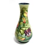 A LARGE MOORCROFT POTTERY 'FUSCHIA' PATTERN VASE the pear shaped body tubelined with trailing