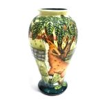 A LARGE MOORCROFT POTTERY VASE of baluster form, tubelined decoration of foxes in front of a stone