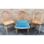AN ERCOL MODEL 203 TYPE WINDSOR ARMCHAIR together with a pair of Ercol stickback windsor dining