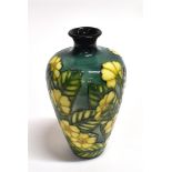 A SMALL MOORCROFT 'BUTTERCUP' PATTERN VASE of baluster form, designed by Sally Tuffin, impressed and