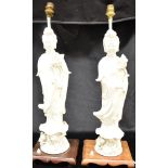 A PAIR OF BLANC DE CHINE FIGURAL TABLE LAMPS modelled as Guanyin, 48cm high excluding bases and