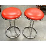 ZOEFTIG: A PAIR OF CHROMED TUBULAR STEEL FRAMED STOOLS with red leather upholstered seats,