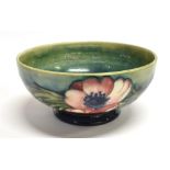 A MOORCROFT POTTERY BOWL DECORATED IN THE 'ANEMONE' on a green ground, impressed facsimile