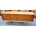 A G-PLAN STYLE TEAK SIDEBOARD with central pair of doors flanked by drop-down cupboard to right hand