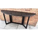 A 1990S BLACK ASH SIDE TABLE of eliptical form, 160cm wide 40cm deep 73cm high