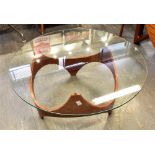 A 'RETRO' CIRCULAR OCCASIONAL TABLE the glass top 86cm diameter, on shaped undertier, 38cm high
