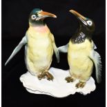 A KARL ENS GROUP MODELLED AS A PAIR OF EMPEROR PENGUINS blue printed factory mark to base, 20cm high