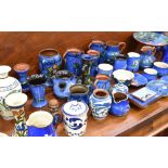 A COLLECTION OF ASSORTED DEVONWARE mostly blue ground, including a Torquay pottery tazza decorated