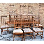 AN ERCOL 'GOLDEN DAWN' EXTENDING DINING TABLE and set of eight chairs including a carver from the '