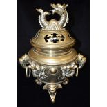 A LARGE BRASS INCENSE BURNER the pierced cover with dragon finial, the body with dragon