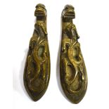 A PAIR OF CHINESE BRONZE ZOOMORPHIC BUCKLES modelled as dragons, each 7.5cm long Condition