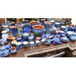 A LARGE COLLECTION OF BLUE GROUND DEVONWARES including a pair of Watcombe vases decorated with