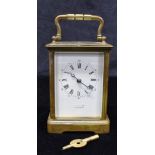 AN EARLY 20TH CENTURY BRASS CASED CARRIAGE CLOCK the enamel dial inscribed 'THOMAS ILFRACOMBE',