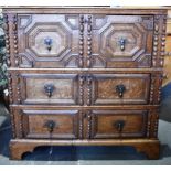 AN OAK CHEST OF THREE LONG DRAWERS the upper drawer has moulded geometric decoration, and above