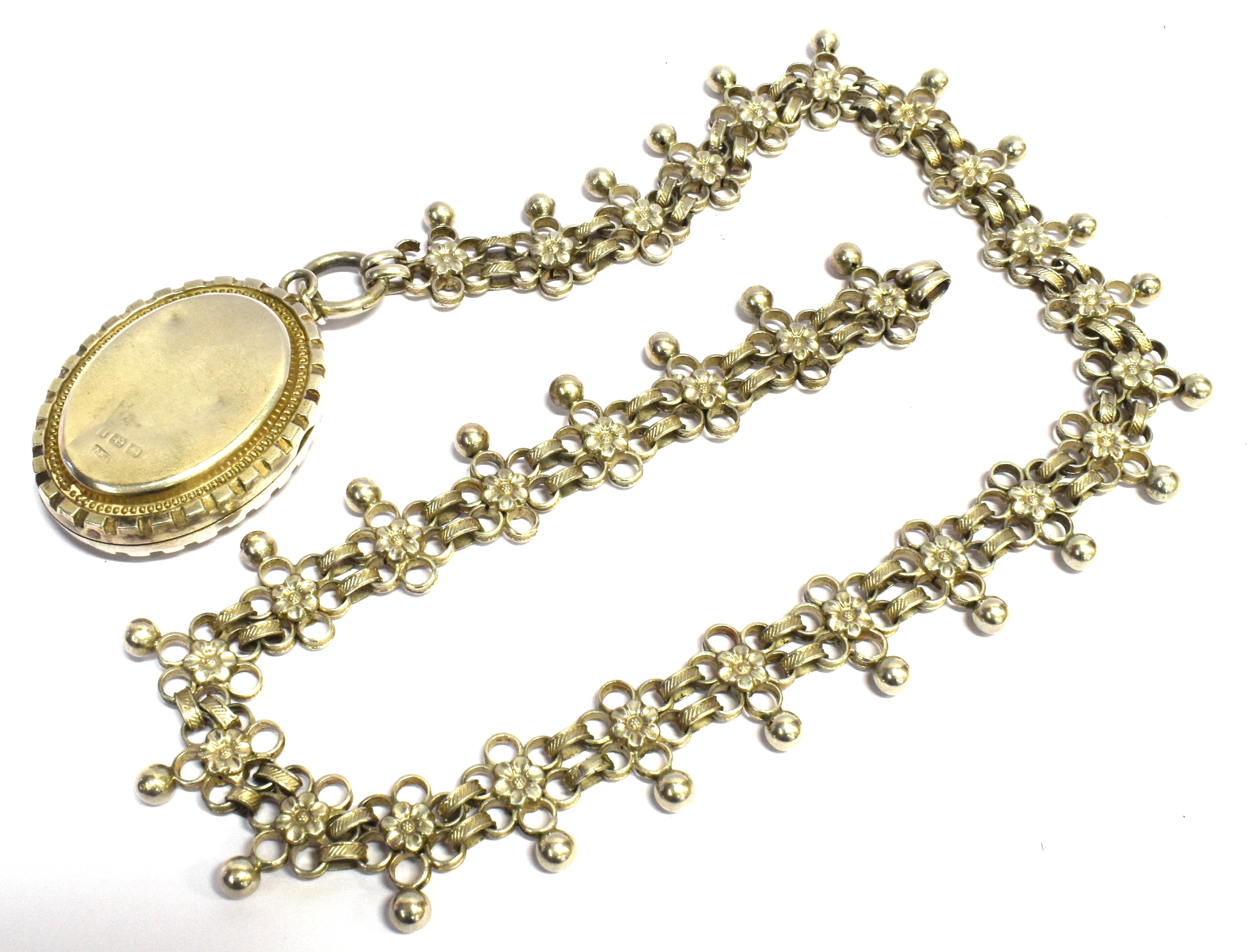 A VICTORIAN SILVER LOCKET with inlaid yellow and rose gold floral decoration to front, 45mm long - Image 2 of 3