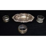 THREE ITEMS OF SILVER Comprising a bon bon dish and 2 napkin rings, the oval embossed