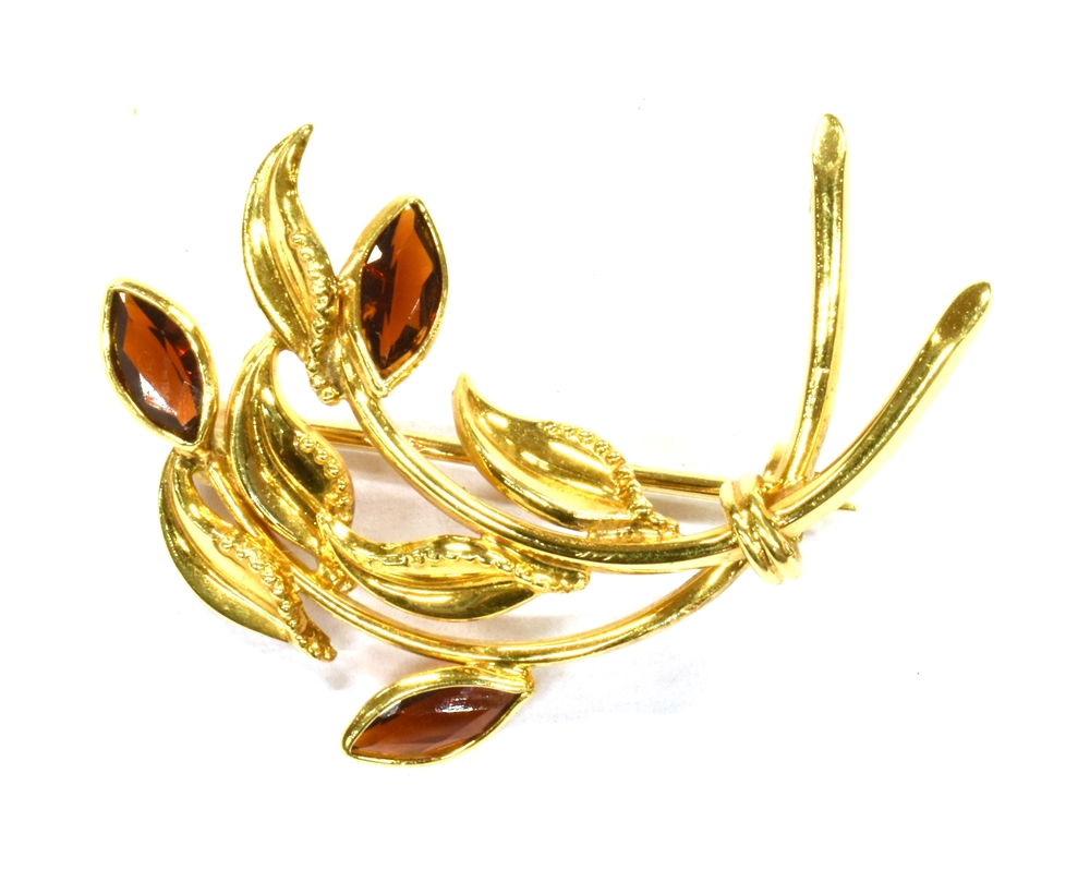 AN 18CT GOLD GARNET SET SPRAY BROOCH the spray of stylised design, set with three marquise cut
