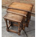 OAK NEST OF THREE TABLES the largest 48cm x 56cm x 34cm, together with a low circular occasional