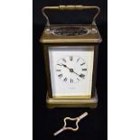 A BRASS CARRIAGE CLOCK the enamel dial with Roman numerals, inscribed 'T R RUSSELL P*RIS', 15cm high