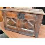 AN OAK COFFER of small proportion of panelled construction, with a plain interior, 33cm x 58cm x