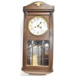 AN OAK CASED WALL CLOCK the spring driven movement striking on four rods, with leaded and bevel