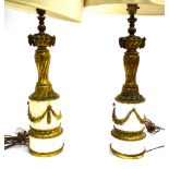 A PAIR OF FRENCH EMPIRE STYLE GILT METAL & CERAMIC TABLE LAMPS with ram's head, spiral flute, laurel