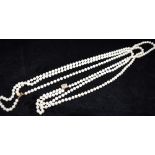 A THREE ROW CULTURED PEARL NECKLACE with a 14ct yellow gold clasp, the uniform round to off round