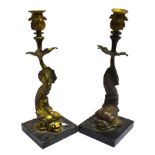 A PAIR OF GILT METAL CANDLESTICKS modelled as stylised dolphins, 36cm high overall Condition