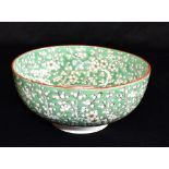A CHINESE PORCELAIN BOWL decorated with a five clawed dragon in a green ground, four character
