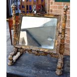 AN ORNATE GILT GESSO SWING FRAME TOILET MIRROR, of rectangular form, flanked by column supports