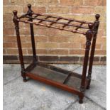 VICTORIAN MAHOGANY STICK STAND with turned support ends and finials and twelve separate dividers,