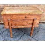 A FRENCH PINE DOUGH BIN with a hinged lid, raised on square, slightly splayed supports, 64cm high,