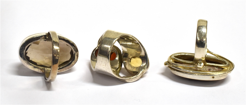 THREE SILVER STONE DRESS RINGS comprising a smoky quartz single stone, a garnet set three stone and - Image 2 of 2