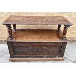 AN OAK MONKS BENCH WITH CARVED DECORATION 107cm wide, 46cm deep, 97cm high as a bench, 79cm folded