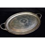 A LARGE SILVER TWO HANDED TRAY The oval tray with central cartouche and crest for the Julian